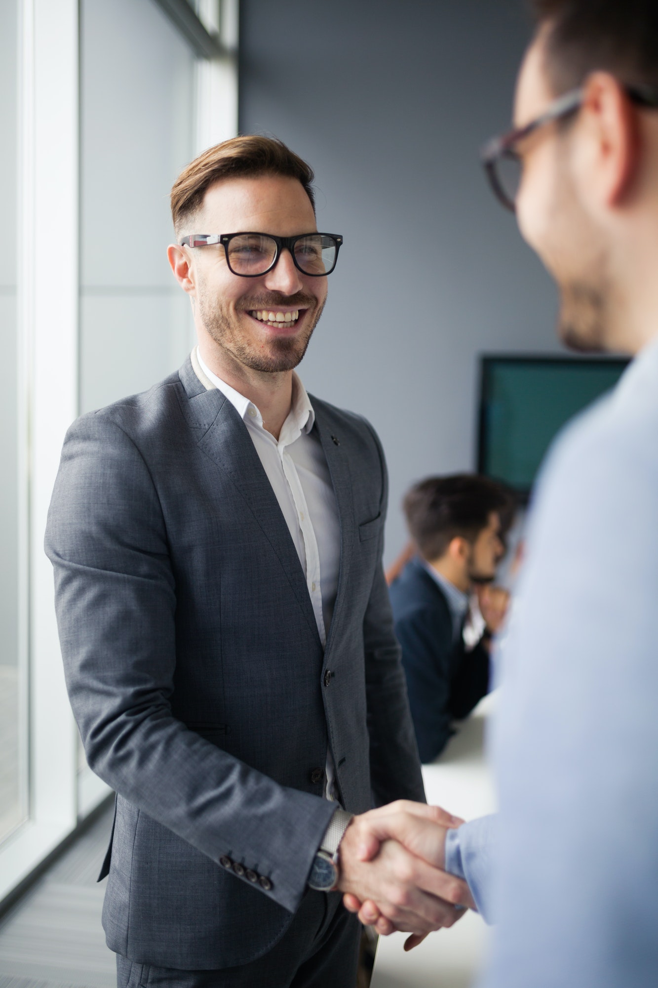 Business people shaking hands in modern office